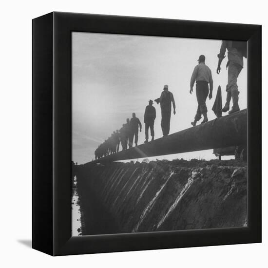 Men Laying Pipeline-null-Framed Premier Image Canvas