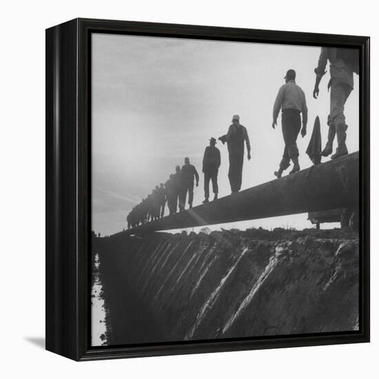 Men Laying Pipeline-null-Framed Premier Image Canvas