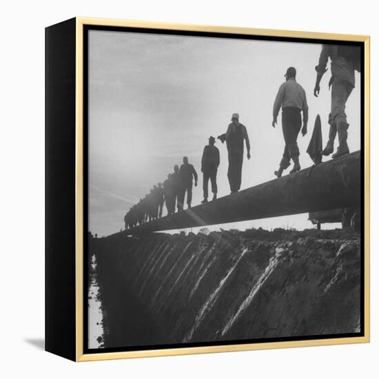 Men Laying Pipeline-null-Framed Premier Image Canvas