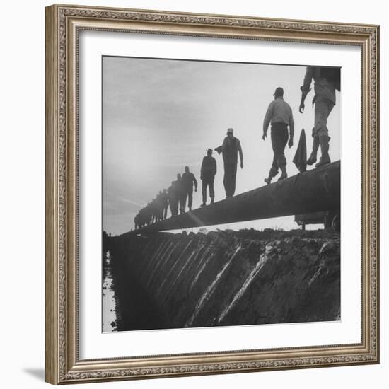 Men Laying Pipeline-null-Framed Photographic Print