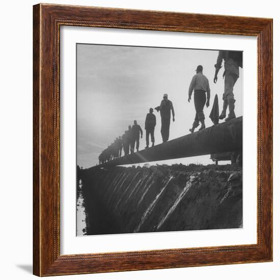 Men Laying Pipeline-null-Framed Photographic Print