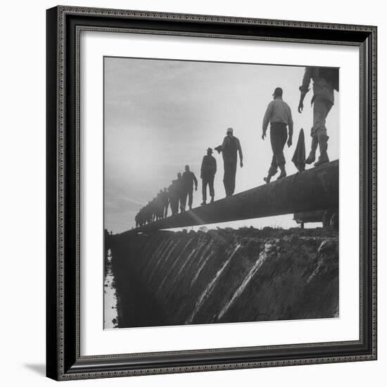 Men Laying Pipeline-null-Framed Photographic Print