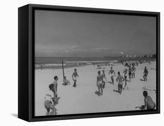 Men Playing a Game of Volleyball on the Beach-null-Framed Premier Image Canvas