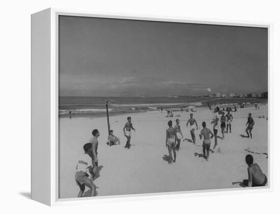 Men Playing a Game of Volleyball on the Beach-null-Framed Premier Image Canvas