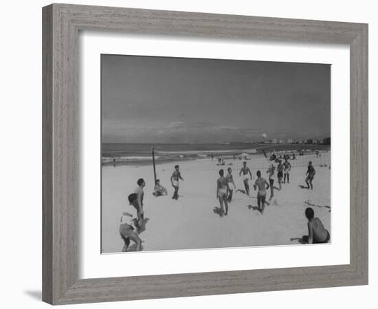 Men Playing a Game of Volleyball on the Beach-null-Framed Photographic Print