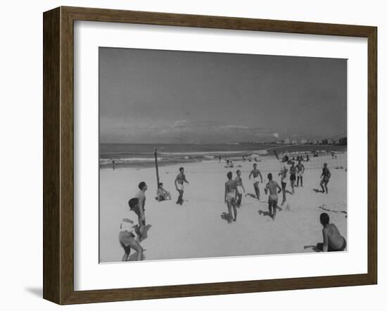 Men Playing a Game of Volleyball on the Beach-null-Framed Photographic Print