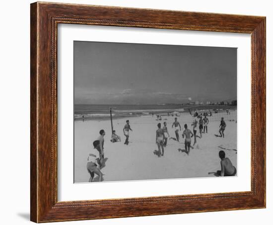 Men Playing a Game of Volleyball on the Beach-null-Framed Photographic Print