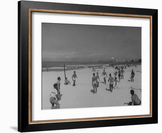 Men Playing a Game of Volleyball on the Beach-null-Framed Photographic Print