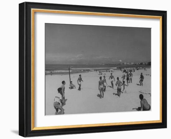 Men Playing a Game of Volleyball on the Beach-null-Framed Photographic Print