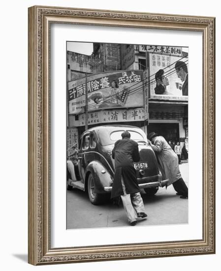 Men Pushing a Car Up a Street, Bilboards Overhead-Carl Mydans-Framed Photographic Print