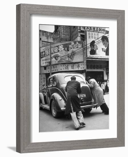 Men Pushing a Car Up a Street, Bilboards Overhead-Carl Mydans-Framed Photographic Print