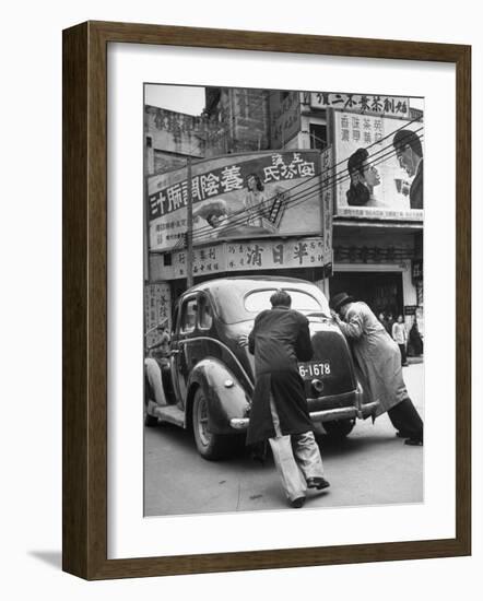 Men Pushing a Car Up a Street, Bilboards Overhead-Carl Mydans-Framed Photographic Print