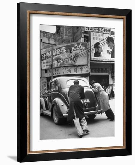 Men Pushing a Car Up a Street, Bilboards Overhead-Carl Mydans-Framed Photographic Print