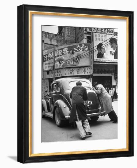 Men Pushing a Car Up a Street, Bilboards Overhead-Carl Mydans-Framed Photographic Print