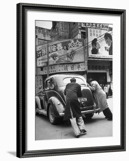 Men Pushing a Car Up a Street, Bilboards Overhead-Carl Mydans-Framed Photographic Print