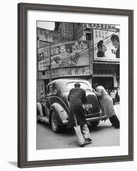 Men Pushing a Car Up a Street, Bilboards Overhead-Carl Mydans-Framed Photographic Print