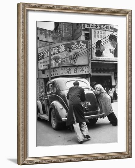 Men Pushing a Car Up a Street, Bilboards Overhead-Carl Mydans-Framed Photographic Print