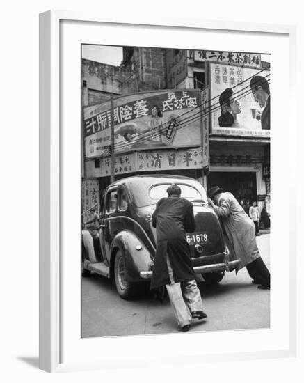 Men Pushing a Car Up a Street, Bilboards Overhead-Carl Mydans-Framed Photographic Print