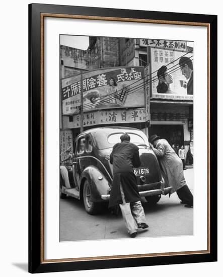 Men Pushing a Car Up a Street, Bilboards Overhead-Carl Mydans-Framed Photographic Print
