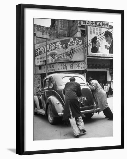 Men Pushing a Car Up a Street, Bilboards Overhead-Carl Mydans-Framed Photographic Print