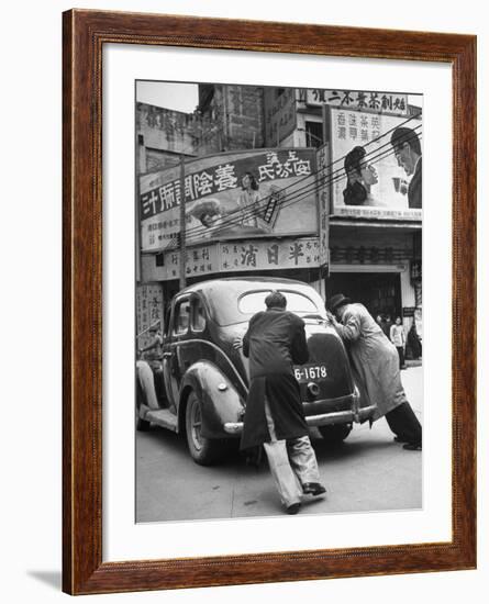 Men Pushing a Car Up a Street, Bilboards Overhead-Carl Mydans-Framed Photographic Print