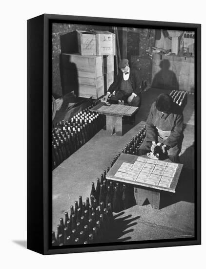 Men Putting Labels on Wine Bottles-Ralph Morse-Framed Premier Image Canvas