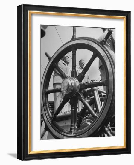 Men Standing at Attention on the Quarter Deck of a Sailing Ship as Viewed Through the Ship's Wheel-null-Framed Photographic Print