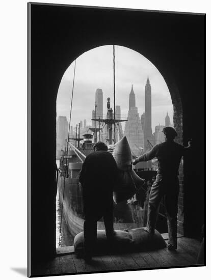 Men Unloading Coffee at Brooklyn Dock. View of Downtown Manhattan in Background-Andreas Feininger-Mounted Photographic Print