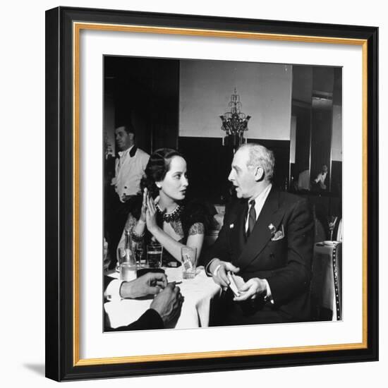 Merle Oberon and Walter Winchell Chatting at the Stork Club-null-Framed Photographic Print