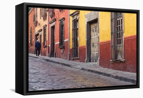 Mexico, San Miguel de Allende. Elderly man walks up sidewalk.-Don Paulson-Framed Premier Image Canvas