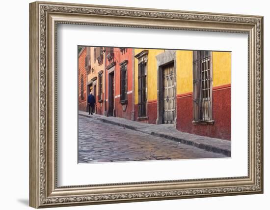 Mexico, San Miguel de Allende. Elderly man walks up sidewalk.-Don Paulson-Framed Photographic Print