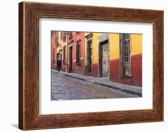 Mexico, San Miguel de Allende. Elderly man walks up sidewalk.-Don Paulson-Framed Photographic Print