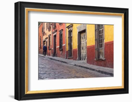 Mexico, San Miguel de Allende. Elderly man walks up sidewalk.-Don Paulson-Framed Photographic Print