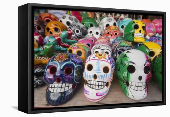 Mexico, Yucatan, Isla Mujeres, colorful ceramic calavera skulls for sale in market.-Merrill Images-Framed Premier Image Canvas