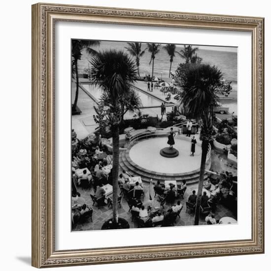 Miami Fashions, Model on Platform Modeling a Casual Cocktail Dress, as Diners Watch-Nina Leen-Framed Photographic Print