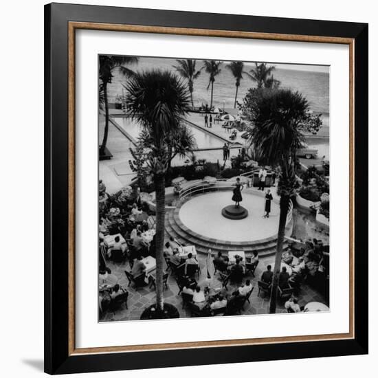 Miami Fashions, Model on Platform Modeling a Casual Cocktail Dress, as Diners Watch-Nina Leen-Framed Photographic Print