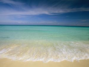 Clear Blue Water and Wispy Clouds Along the Beach at Cancun by Michael Melford