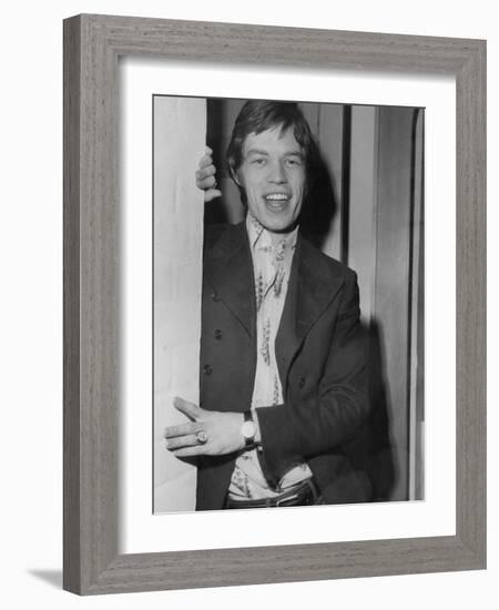 Mick Jagger in a Door-Associated Newspapers-Framed Photo