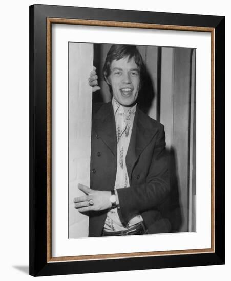 Mick Jagger in a Door-Associated Newspapers-Framed Photo