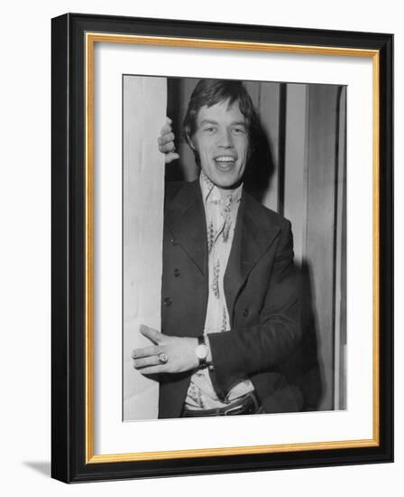 Mick Jagger in a Door-Associated Newspapers-Framed Photo