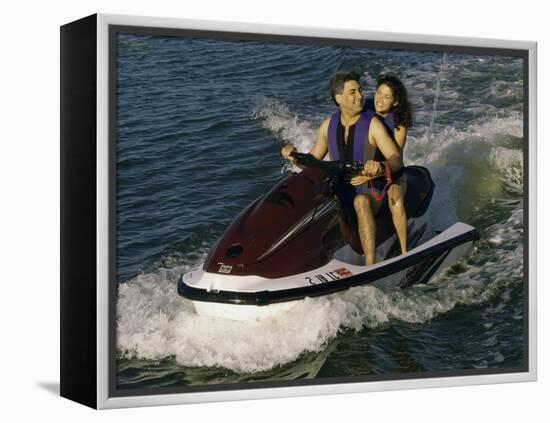 Mid Adult Couple Riding a Jet Ski-null-Framed Premier Image Canvas