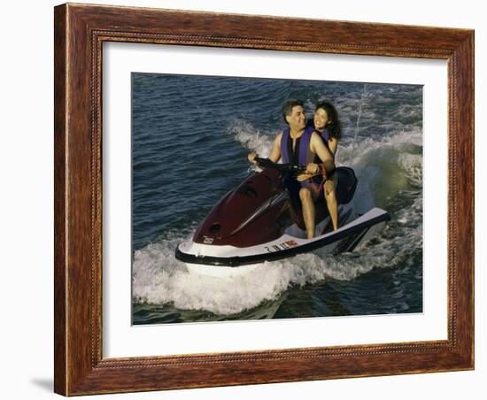 Mid Adult Couple Riding a Jet Ski-null-Framed Photographic Print