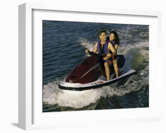 Mid Adult Couple Riding a Jet Ski-null-Framed Photographic Print