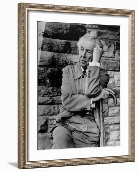 Midwestern Architect Frank Lloyd Wright sits against stone wall-Eliot Elisofon-Framed Premium Photographic Print