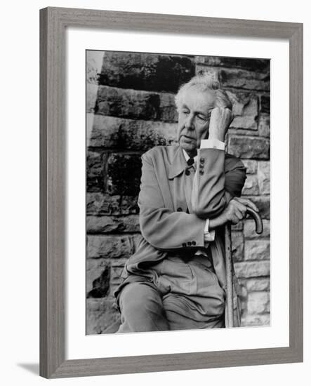 Midwestern Architect Frank Lloyd Wright sits against stone wall-Eliot Elisofon-Framed Premium Photographic Print