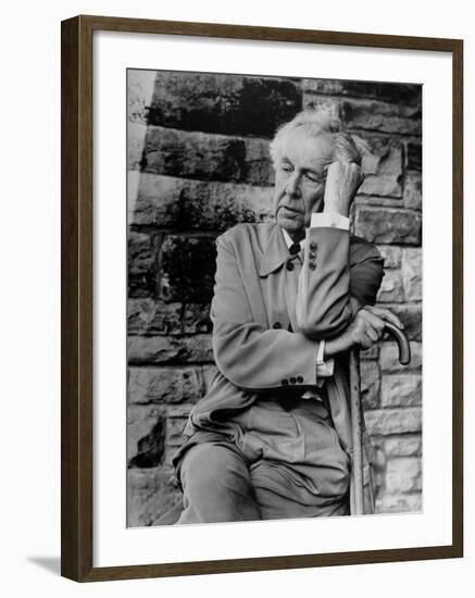 Midwestern Architect Frank Lloyd Wright sits against stone wall-Eliot Elisofon-Framed Premium Photographic Print