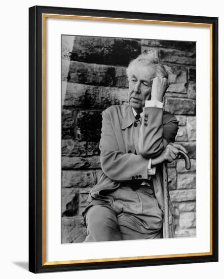 Midwestern Architect Frank Lloyd Wright sits against stone wall-Eliot Elisofon-Framed Premium Photographic Print