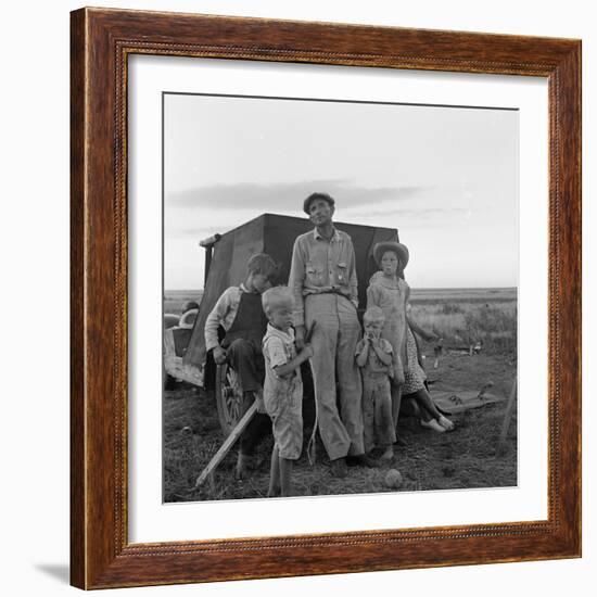 Migrant farm labourer with his children on the road in Texas, 1938-Dorothea Lange-Framed Photographic Print