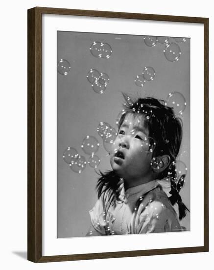 Mili's High Speed Camera Catches Little Girl Watching Shower of Soap Bubble Drifting Down on Her-Gjon Mili-Framed Photographic Print