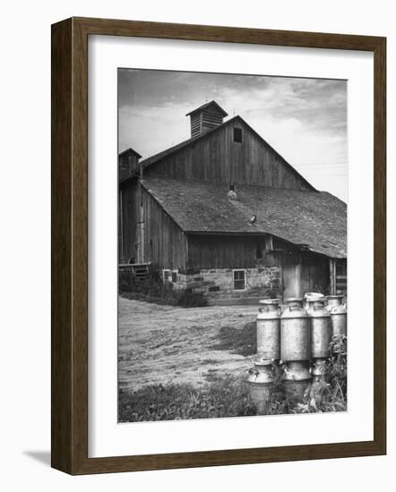 Milk Cans Being Stored on a Farm-null-Framed Photographic Print